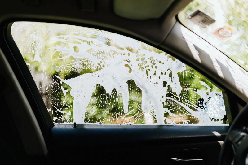 Professional mobile detailer cleaning a vehicle interior in Tucson, Arizona