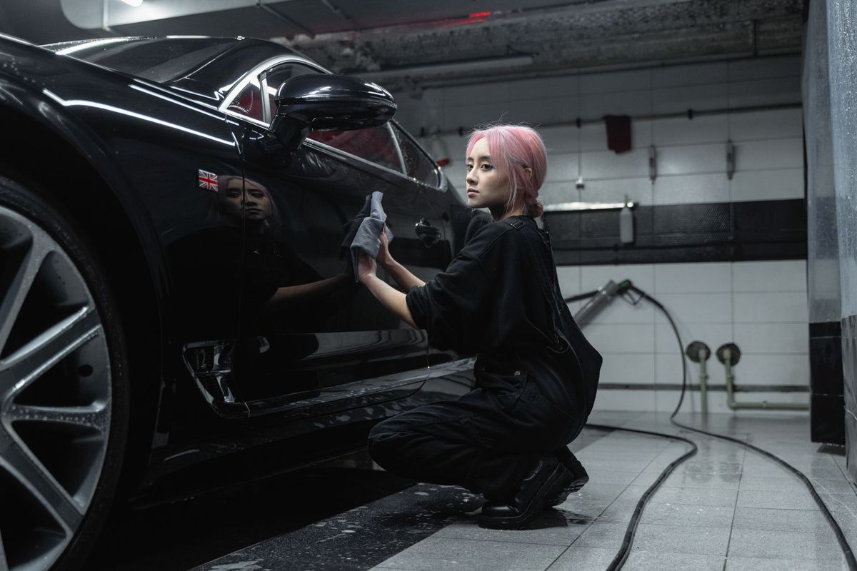 Detailer applying vehicle protection during mobile auto detailing in Tucson