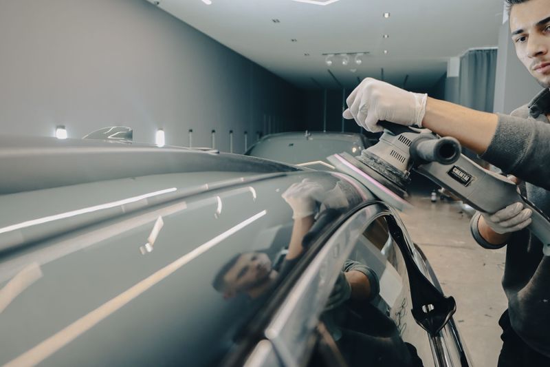 Detailer treating stains on vehicle upholstery in Tucson, Arizona